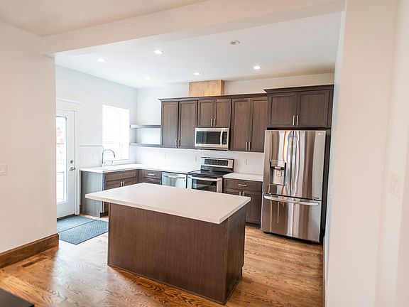 Open concept kitchen with walnut cabinets