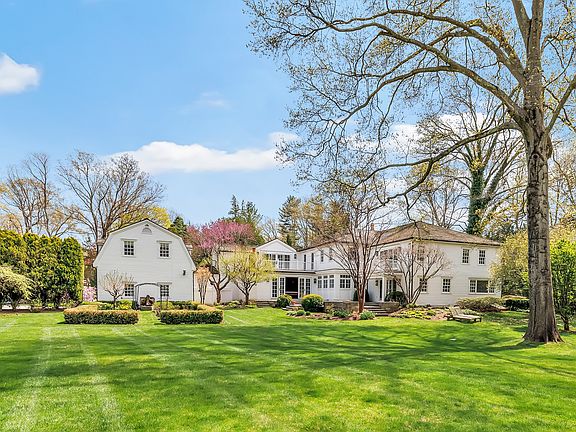 The home is set on nearly 3 acres of stunningly manicured, park-like grounds, creating a sense of privacy and serenity