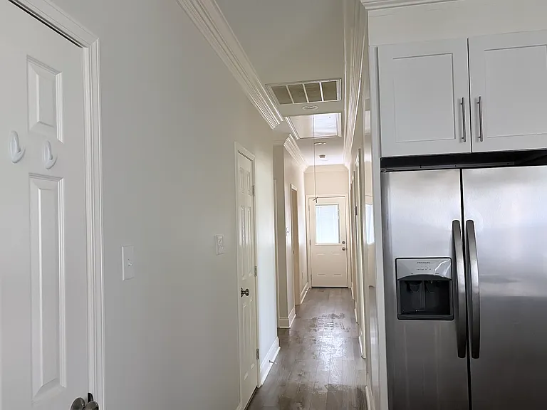 View from the kitchen to the half bath, laundry room, 2nd and 3rd bedrooms, and guest bathroom.