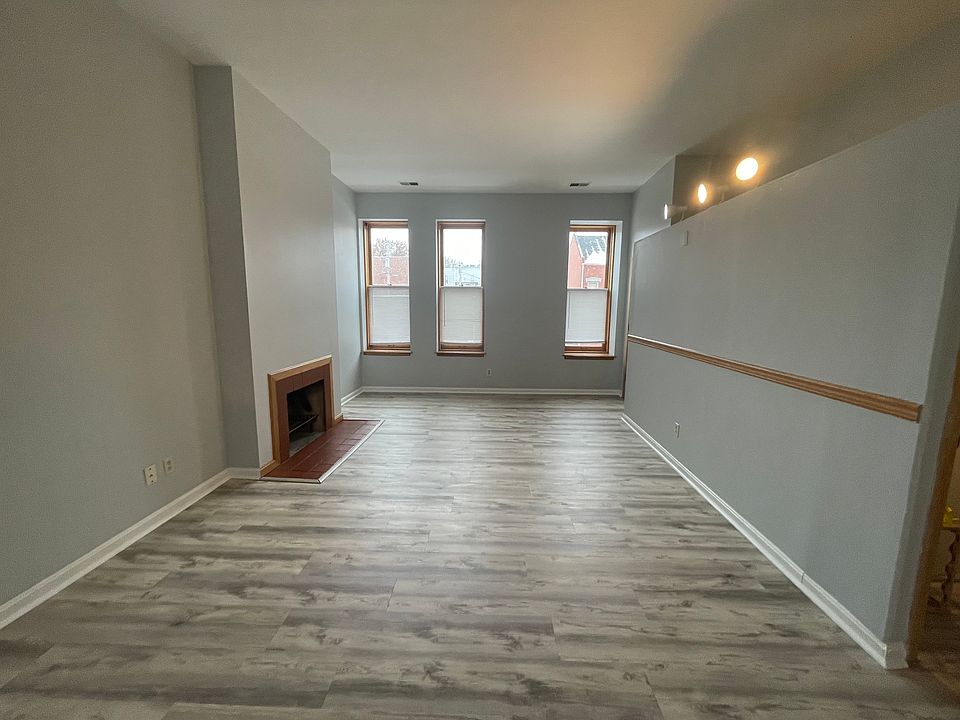Lots of natural light and decorative fireplace.