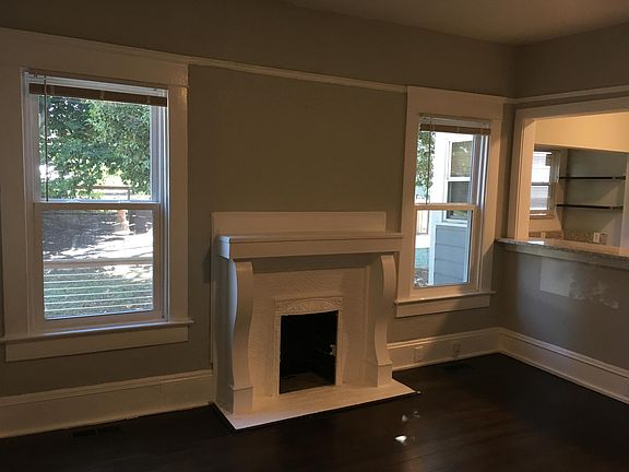 living room with bar area opening into kitchen