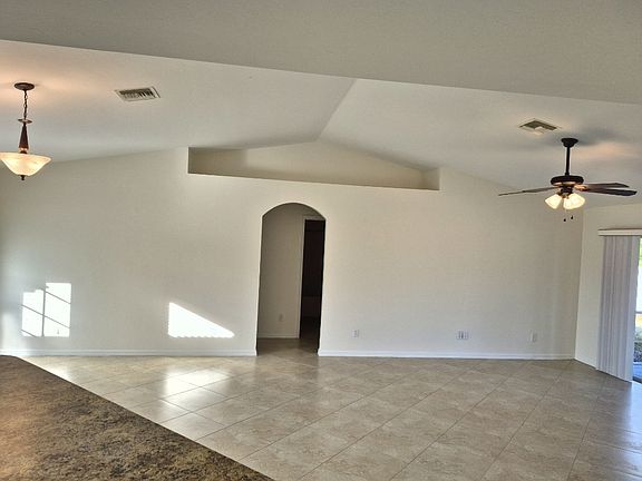living area with decorative shelf, doorway to front two guestrooms