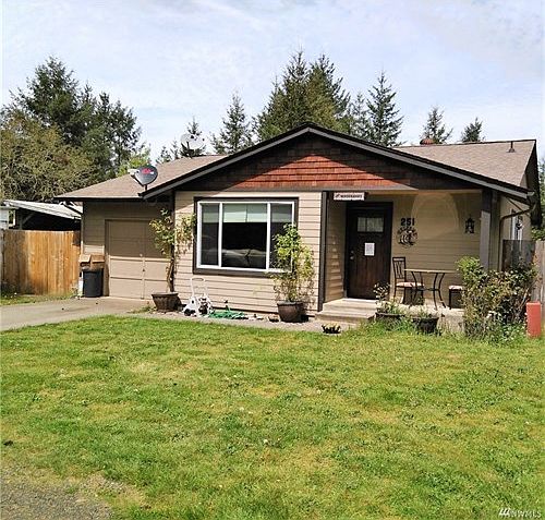 Front of home with a small sitting area.