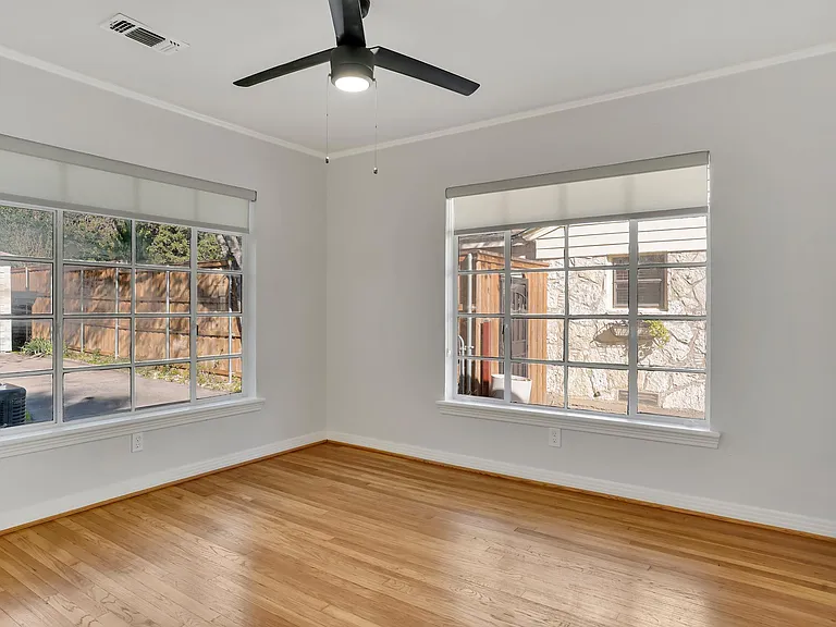 Back bedroom with a ceiling fan.