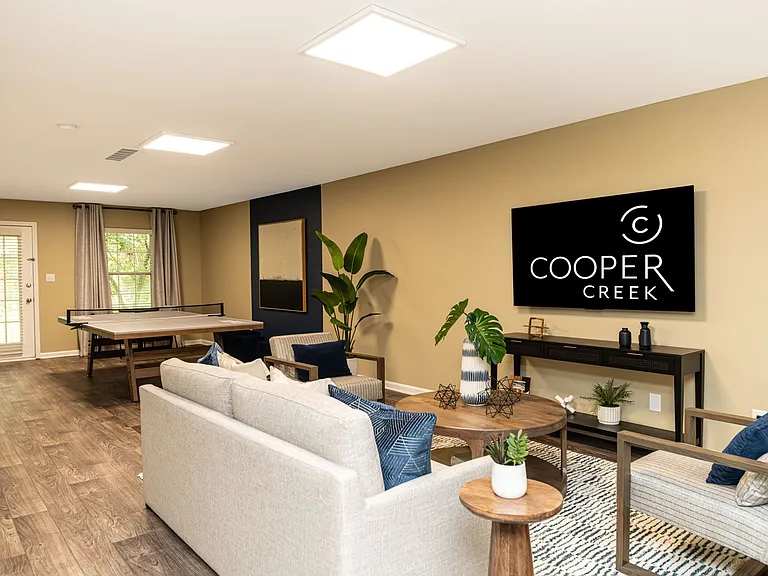 Spacious living room with hardwood-style flooring and built-in lighting