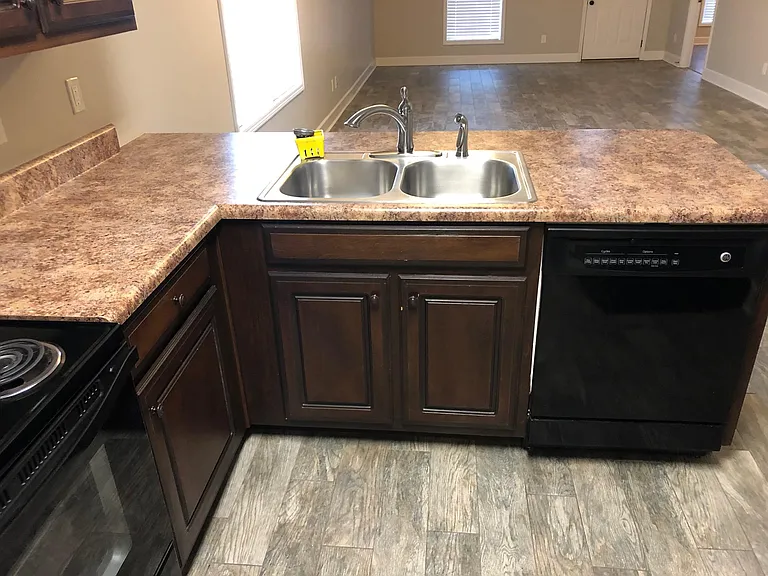 Kitchen with bar top open to dining and den area.