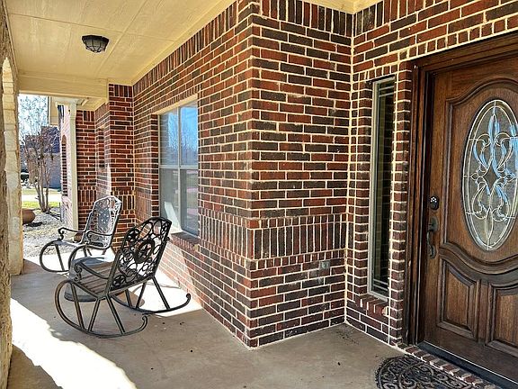 This large covered front porch comes with these rocking chairs and table. It's the perfect spot to enjoy a morning cup of coffee or just relax and watch the world go by.