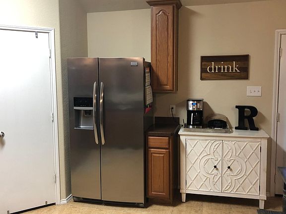 Frigidaire refrigerator and a walk-in pantry.