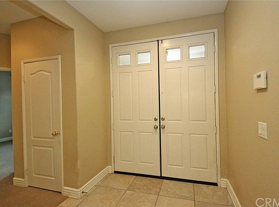 Formal entryway with a coat closet