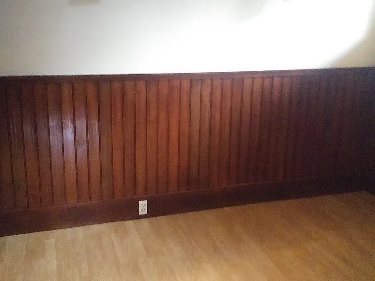 Bedroom with Natural Wood, Period Wall Sconces and High-End Laminate Flooring. Bedroom, Living Room, and closets have the same laminate flooring.