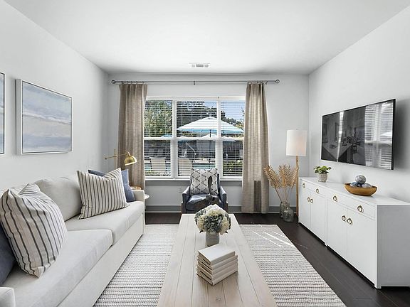 Contemporary Apartment Living Room with Plush Sofa and Accent Chair