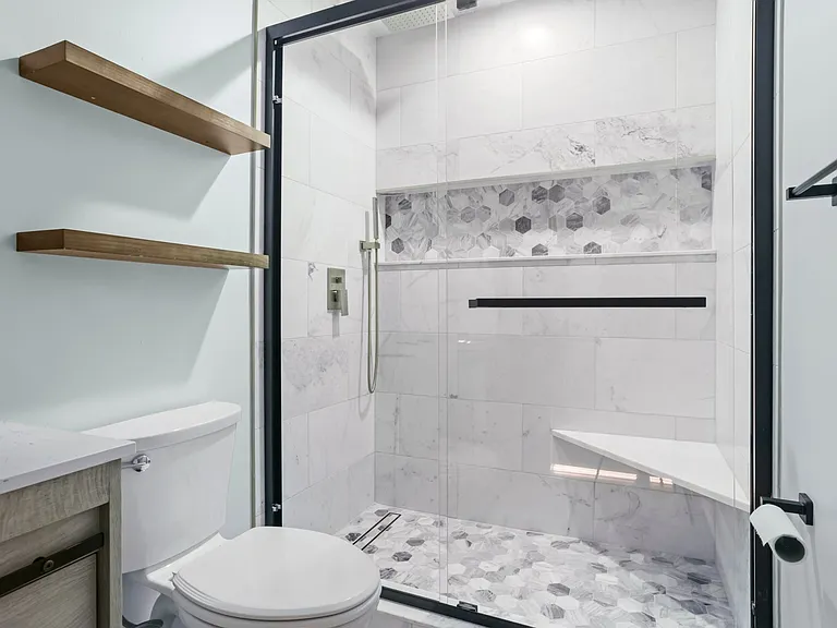 This master bathroom is fully marble and boasts a shower seat, an incredible, full-length niche, and a French drain. It doesn't get any nicer than this!