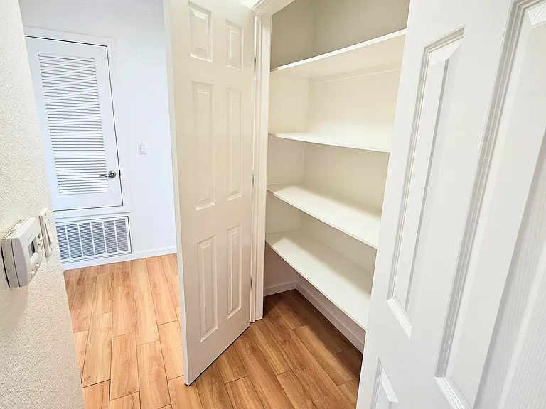 Hall linen closet. Central heating but no air conditioning. There is a "cool" setting, but only forced air.