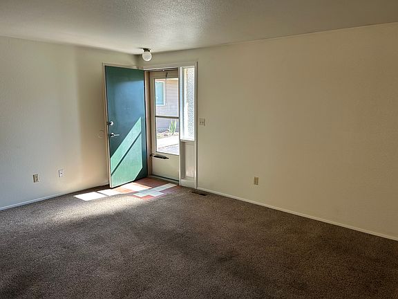 View of living room to front door