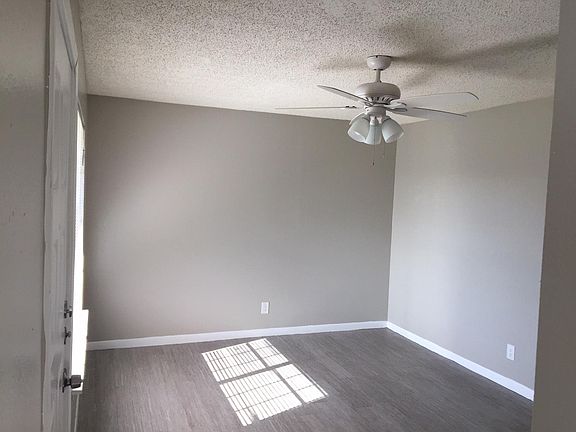 Living Room w/ ceiling fan and new vinyl flooring