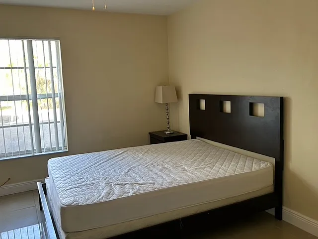 furnished bedroom with new queen bed set, desk and office chair