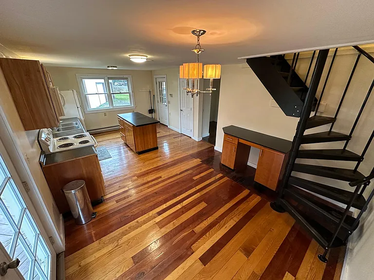 kitchen/ spiral staircase to 2nd floors. hallway and kitchen entrance in far corner