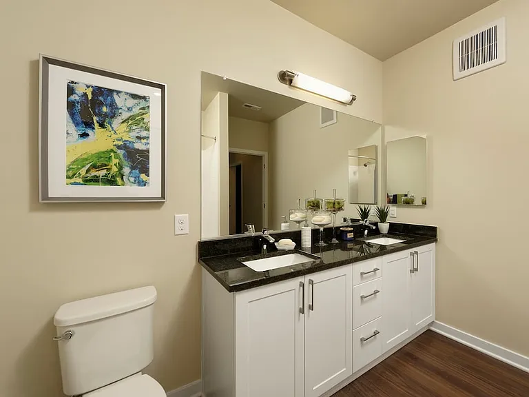 Hunt Valley - Finish Package I Dual vanity bathroom with white shaker cabinetry, granite countertop and hard surface flooring