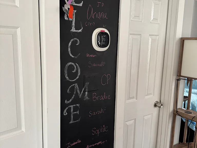 Downstairs foyer with chalk wall next to the powder room door.