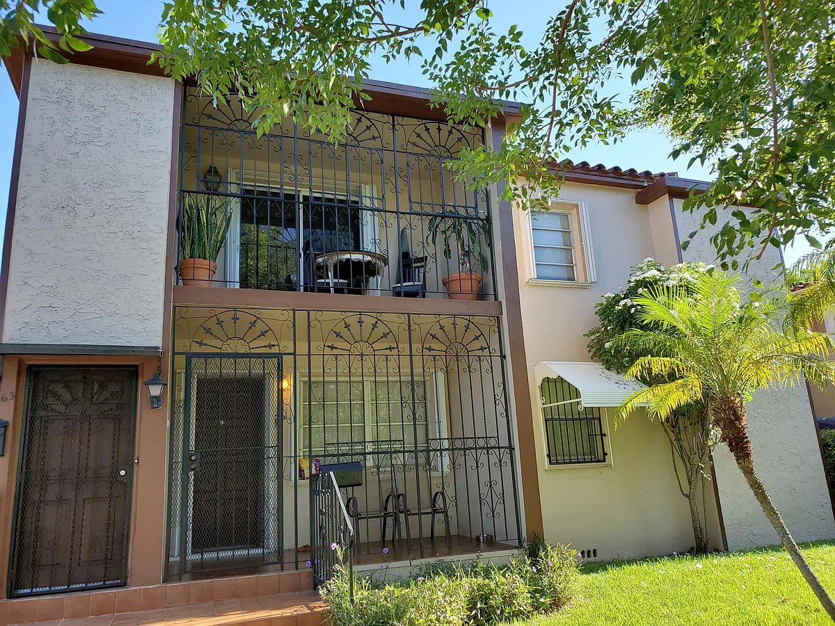 Building Front 2nd View. Upper unit rental balcony - 3763 SW 26th Ter