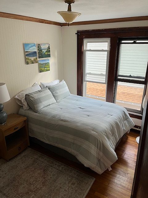 Bedroom pictured with a full sized bed. The other bedroom, has a queen sized bed.