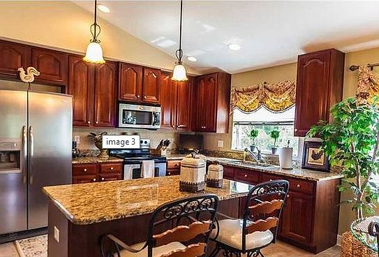 Kitchen:   Tile Backsplash, Granite Counters, Stainless Appliances