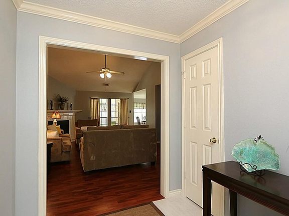 Fabulous entry features crown molding with a view of the family room.