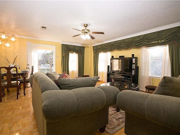 Bright living room with beautiful hardwood floors and room for dining