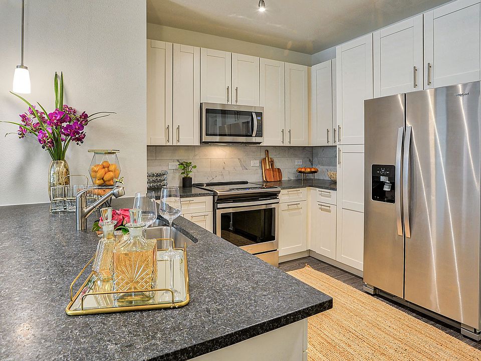Well-appointed kitchens feature granite or quartz countertops and tiled backsplashes