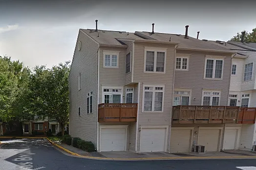 Back of unit with two car garage and balcony.