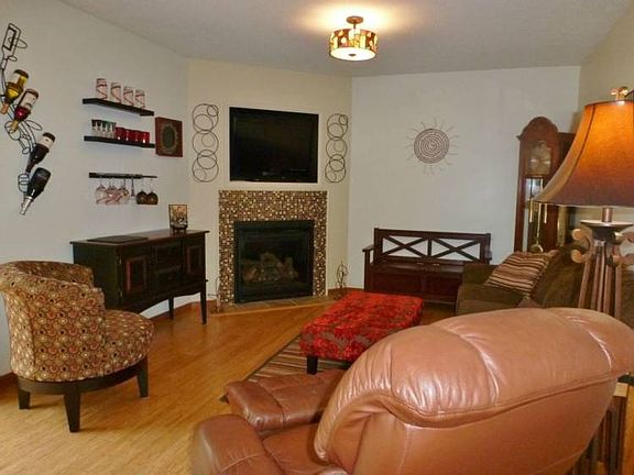Originally used as a dining room, current owners are using it as a nice sitting area or family room.  The gas-log fireplace has a beautiful glass tile surround that nicely complements the granite counters in the kitchen!