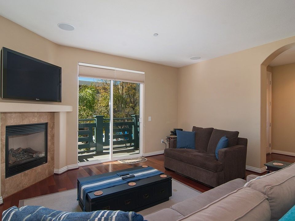 Front ,west facing, living room with cozy fireplace.  elegant and rich looking wood flooring.