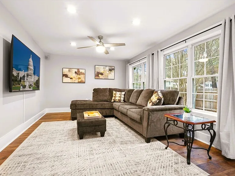 Generous-sized family room off of the sunroom on the first floor. 75" TV