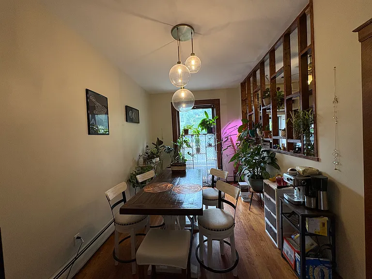 Dining room with fancy lighting and huge window for natural light.