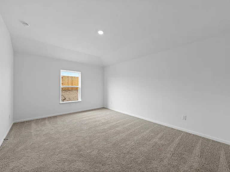 Master bedroom with lush carpet flooring.