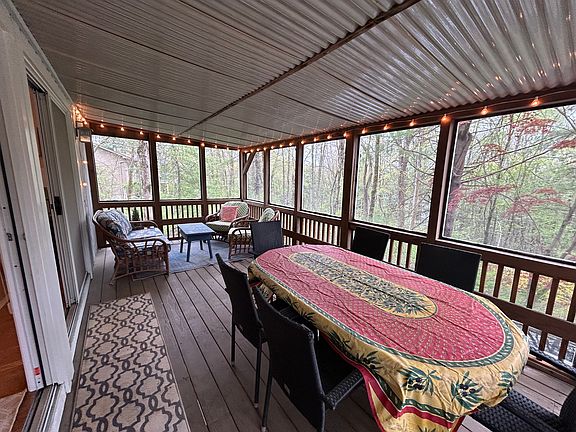 Perfect screen porch with dining table and soft seating area.