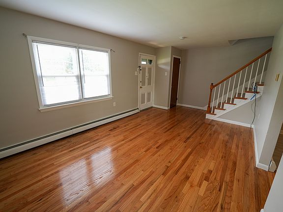 Living room with a coat closet and 2 sets of windows bringing in great natural light.