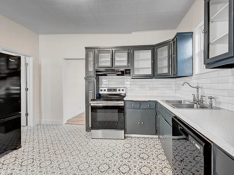 Spacious kitchen leads to dining room and 3/4 bath and features a HUGE pantry and glass-fronted cabinets!