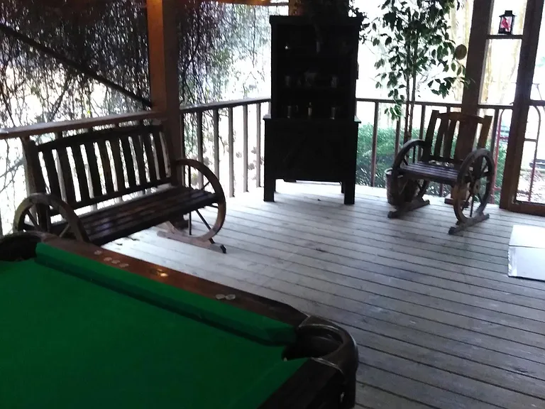 Side porch 28ft x 22ft with ceiling fan, pool table & wester