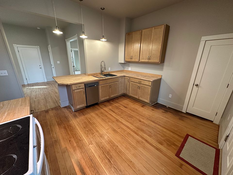 Modern kitchen with 9' ceilings. New cabinets, LED light fixtures, and appliances. Door to right provides private access to unfinished basement.
