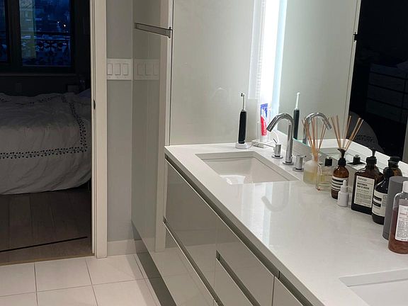 master bathroom with double sinks and lighting mirror