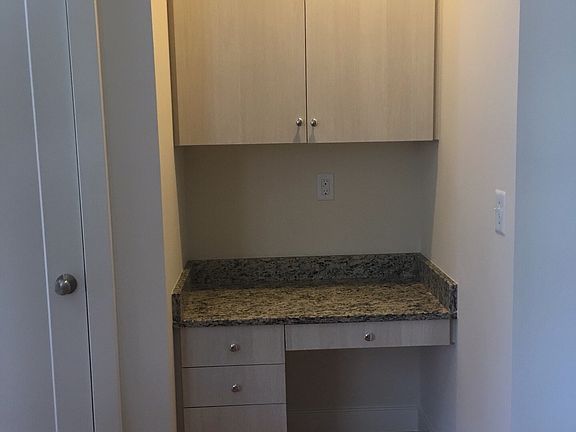 Desk and cupboards by kitchen