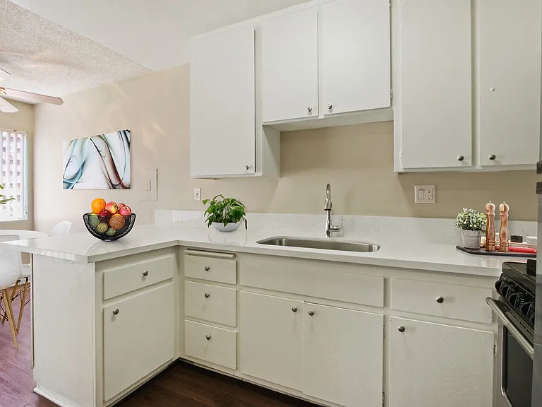 Kitchen With a single sink, small breakfast bar, stainless steel refrigerator