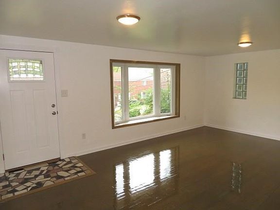 Gleaming hard wood floors, new front door, LED lighting fixtures and woodwork in the living room.