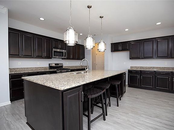 Massive island with granite with seating.