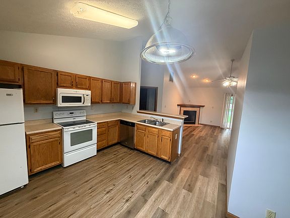 Kitchen and view to the living room with a gas fireplace