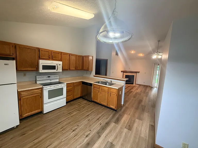 Kitchen and view to the living room with a gas fireplace