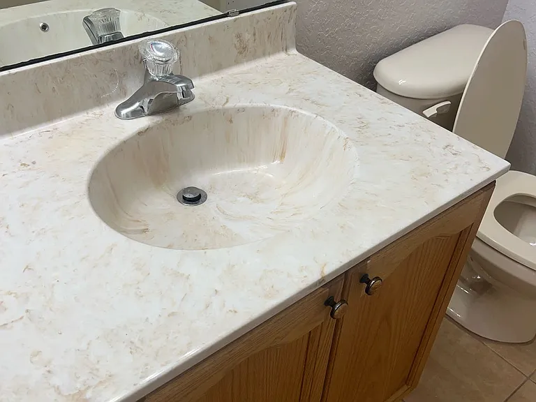 62 - Secondary bathroom with sink, cabinet, and toilet.