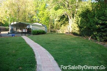 back
						:
						looking from the patio back to the carport/garages