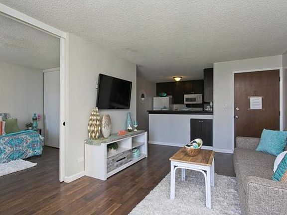 Living Room, Fully stocked kitchen and a sliding door into one of the bedrooms